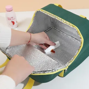 Portable insulated lunch bag for office and school, featuring easy-to-clean foil interior.