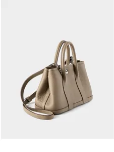 Detailed view of taupe genuine leather shoulder bag featuring premium texture and hardware.