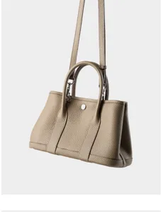 Taupe leather garden tote bag, classic pebbled texture handbag with dual top handles detail.