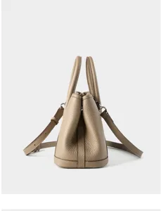 Side detail view of premium leather women garden tote handbag, classic taupe bucket design.
