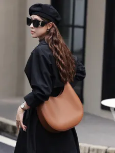 Minimalist genuine leather crescent hobo bag for women, stylish underarm shoulder tote.