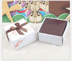 Mini square gift packaging box detail featuring elegant brown ribbon and cherry blossom print.