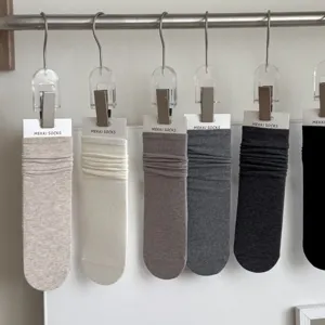Solid color cotton slouch socks for women, versatile early autumn casual hosiery style.