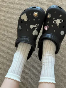 White dot socks and black clogs with trendy charms, stylish and breathable summer wear.