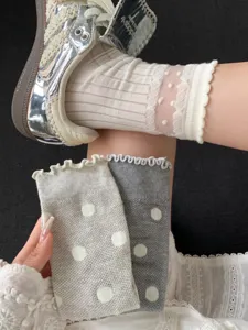 Sheer white polka dot sheer summer mid tube socks with delicate lace ruffle trim for women.