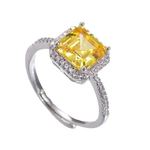 Radiant princess cut yellow zircon halo ring with sparkling micro-pave side stones in silver.