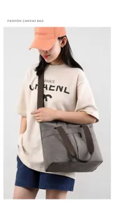 Grey canvas shoulder bag for women, large capacity casual tote bag with sturdy brown straps.