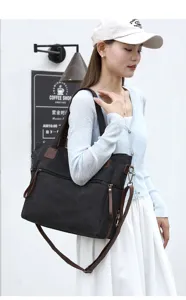 Classic black canvas tote bag with brown leather straps, large capacity for daily travel.