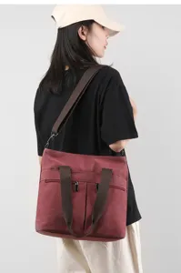 Large capacity canvas shoulder bag for women, versatile tote crossbody bag with brown straps.