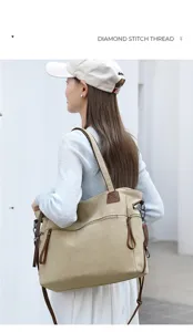 Detail view of a large canvas tote bag with brown leather trim, perfect for travel and daily use.