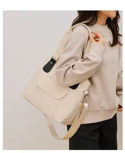 Casual nylon shoulder bag with contrast strap and front pocket detail, stylish and versatile.