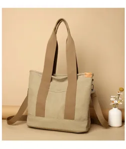 Detailed view of the casual khaki canvas tote bag, featuring sturdy handles and spacious interior.