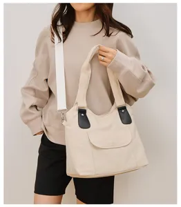 Casual canvas shoulder bag for women, stylish tote handbag with crossbody strap and pockets.
