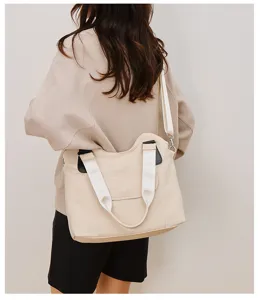 Details of the stylish beige canvas shoulder bag for women, featuring durable webbing straps.