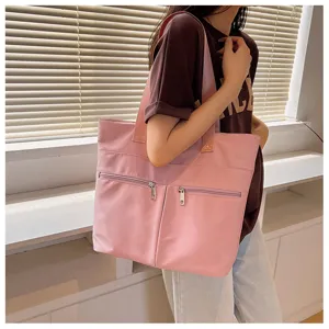 Pink nylon tote bag for women, large capacity casual shoulder bag with front zipper pockets.