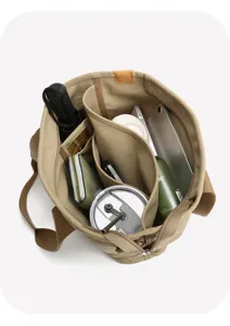 Casual canvas tote bag with large capacity and multi-compartment interior for daily use.