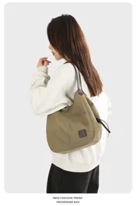 Canvas shoulder bag for women, casual hobo tote with leather strap and drawstring detail.