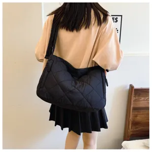 Detailed view of women's black quilted shoulder bag, casual cotton-padded crossbody design.