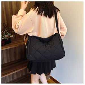 Black quilted shoulder bag for women, large capacity puffer crossbody tote bag for daily use.