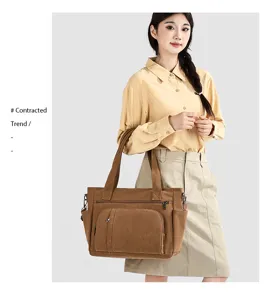 Detailed view of the retro canvas tote bag with front pocket, worn by model for daily use.