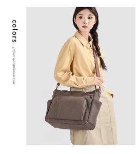 Vintage canvas crossbody bag with multiple pockets and adjustable strap for daily use.