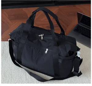 Detailed view of black travel duffel bag, durable fabric, sturdy handles and smooth zippers.