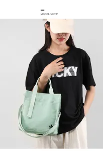 Detail view of the stylish canvas crossbody tote bag, showcasing large capacity.