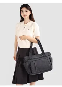 Detailed view of vintage canvas tote bag, multi-pocket casual shoulder travel handbag.