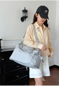 Casual grey travel duffel bag for women and men, lightweight gym sports bag with shoulder strap.