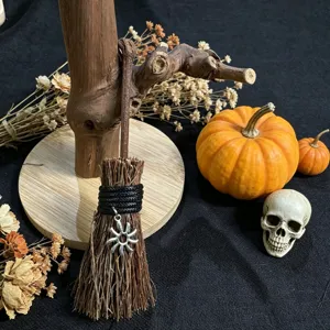 Halloween miniature twig broom ornament with sun charm and festive decor items for party setup.