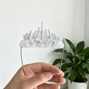 Handcrafted crystal stone pocket decoration detail showing transparent crystal pillars and silver leaves.