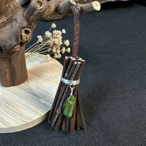 Handmade twig broom ornament with green crystal pendant detail for Halloween daily decor