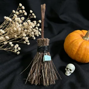 Mini crystal witch broom ornament close up, handmade natural wood Halloween table decor piece.