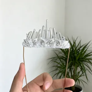 Handmade clear quartz crystal crown detail view with silver leaf and raw stone base design.