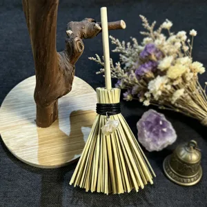 Close-up of the miniature witch broom hanging ornament with crystal pendant and natural fibers.