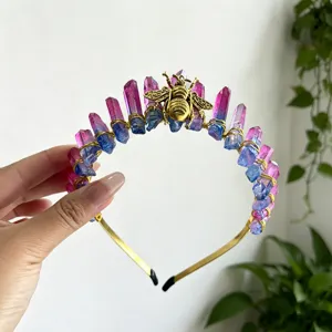 Close-up detail of the crystal crown headband featuring colorful crystals and a gold bee.