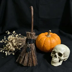 Halloween witch broom detail shot featuring crystal pendant and seasonal festive decor.