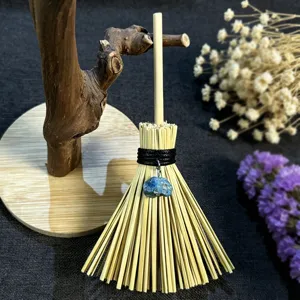 Detailed view of the mini Wicca witch broom hanging pendant with a natural blue crystal stone.