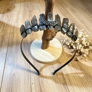 Detailed view of the 11-crystal tiara featuring raw stones and an ornate silver moon pendant.