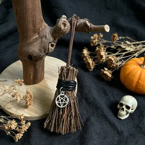 Miniature witch broom Halloween decoration ornament with pentagram pendant and wooden stand.