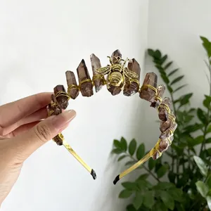 Detailed shot of the crystal raw stone and gold bee headband, showcasing exquisite handmade wire.