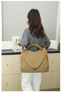 Detailed view of the vintage nylon shoulder bag worn by a model, showing large capacity.