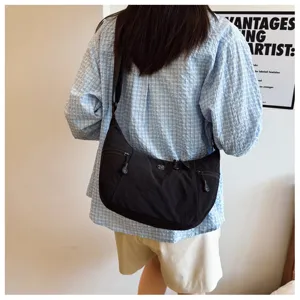 Black nylon crossbody bag detail view, casual street style daily shoulder bag design.