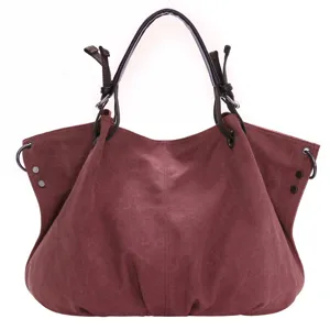 Close-up view of the casual burgundy canvas hobo bag, showcasing the durable fabric and handles.