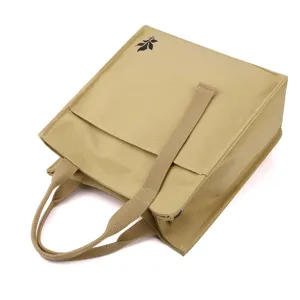 Stylish khaki canvas tote bag with top handles and structured design for daily use.