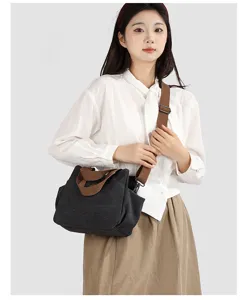 Close-up detail of the vintage canvas shoulder bag highlighting the durable brown straps.