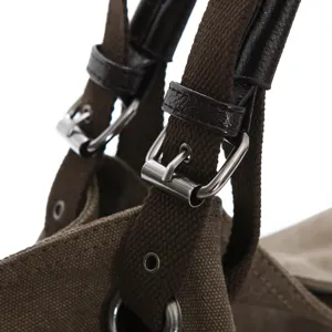 Women canvas shoulder bag detail view, fashion retro casual tote handbag with metal buckles.