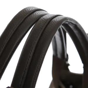 Premium brown leather handbag handle detail, durable stitching, elegant daily tote bag style.