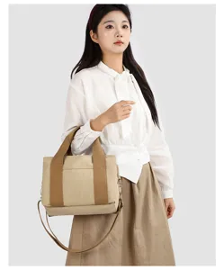 Vista dettagliata della borsa a tracolla in tela, colore beige, accessorio casual resistente.