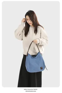 Casual blue canvas hobo shoulder bag for women, featuring top handles and large capacity.